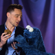 Illustration for article titled This video of Tom Hiddleston teaching Cookie Monster about delayed gratification is oddly sexual